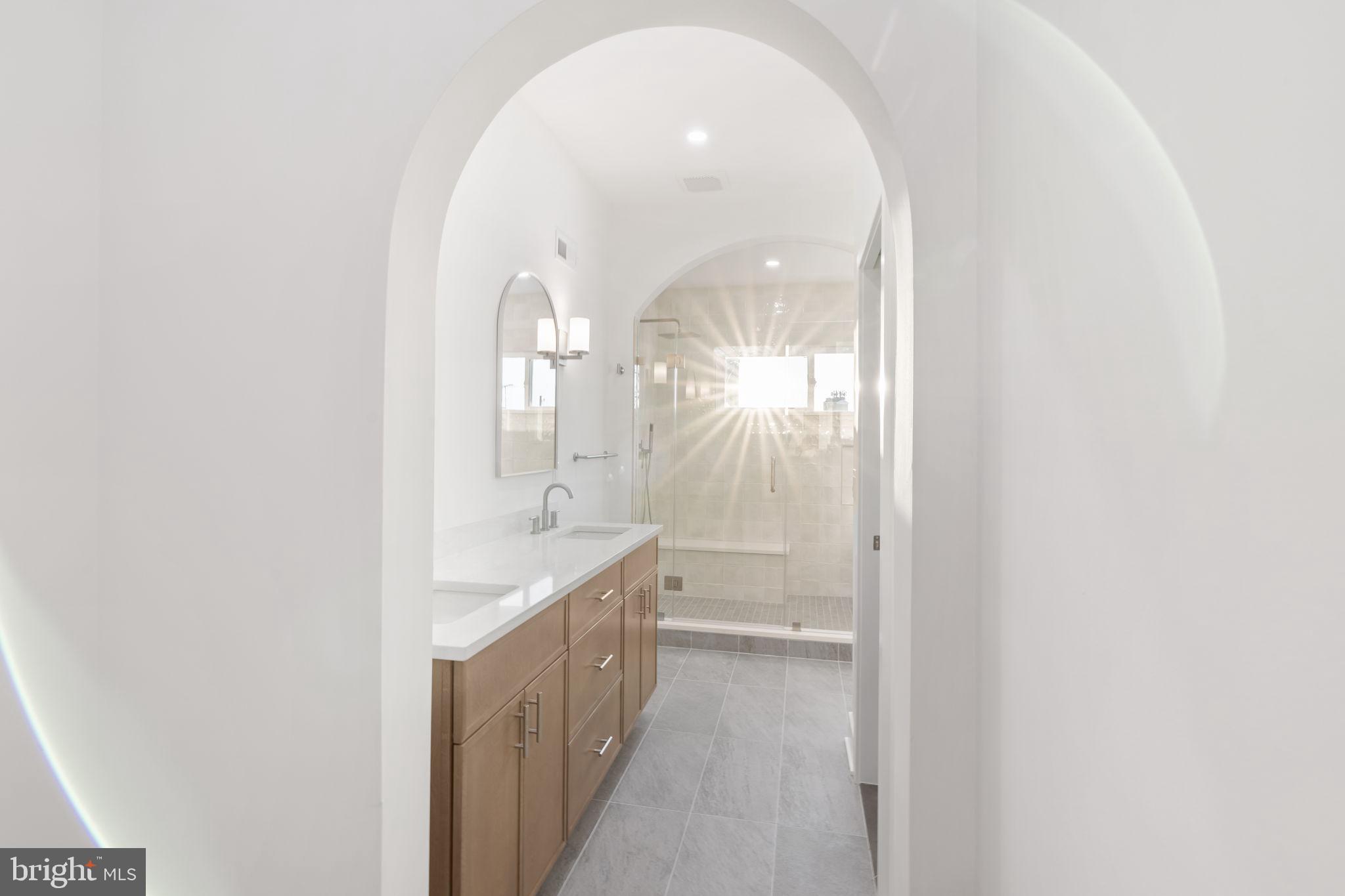 1318 South 8th Street Philadelphia, PA 19147 - Photo 27 of 47 a bathroom with a double vanity sink and a mirror