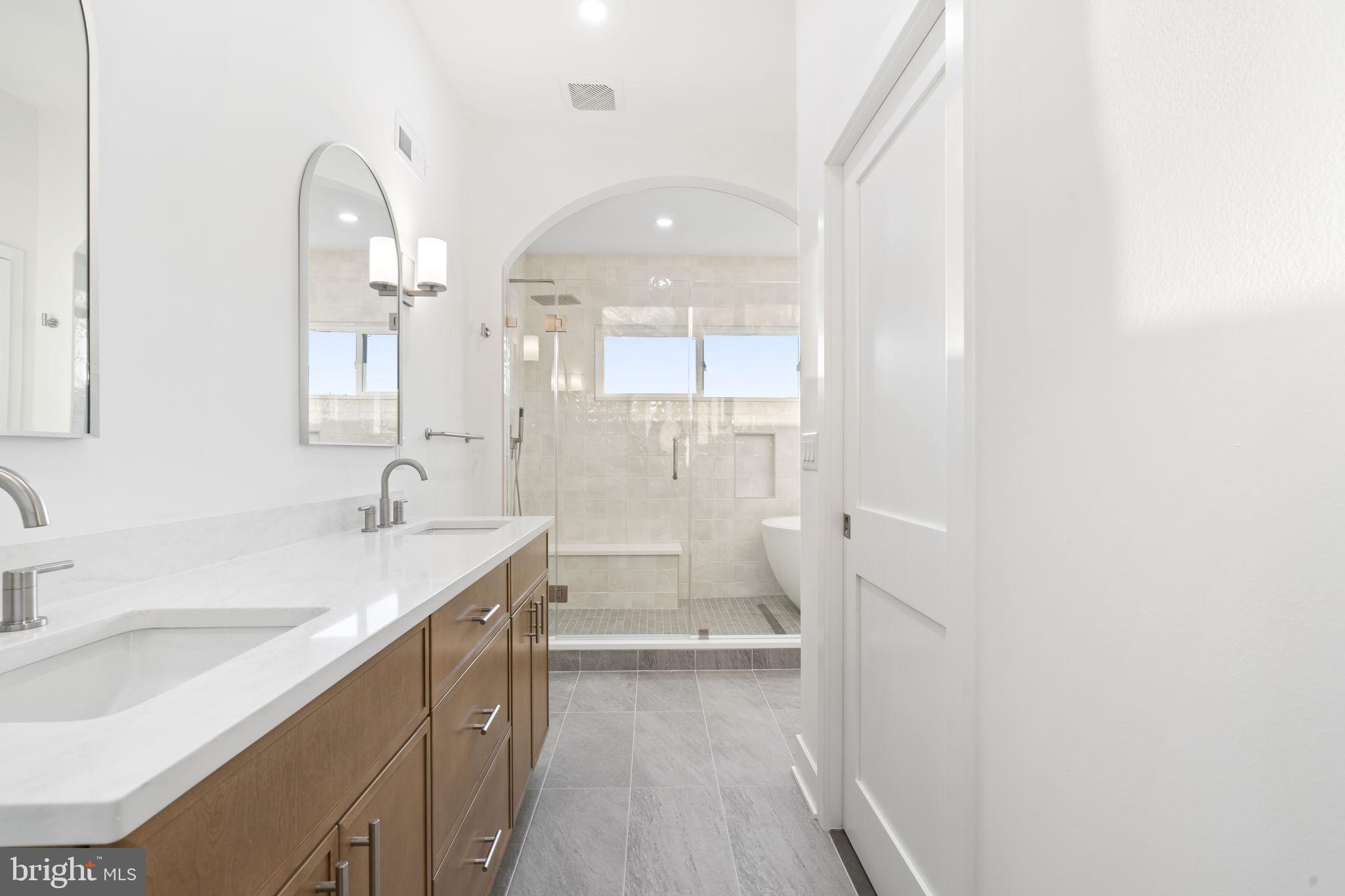 1318 South 8th Street Philadelphia, PA 19147 - Photo 29 of 47 a bathroom with a sink a large mirror and a bathtub