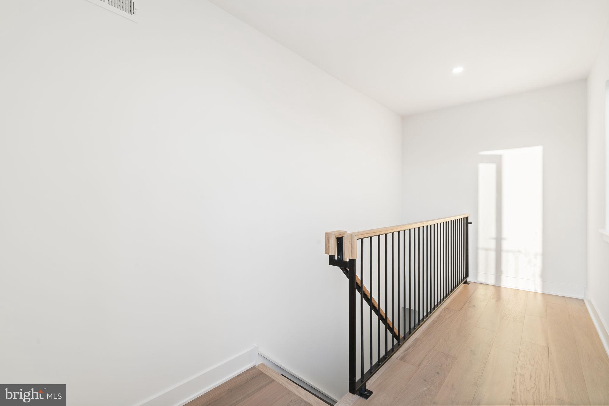 1318 South 8th Street Philadelphia, PA 19147 - Photo 34 of 47 a view of a hallway with wooden floor
