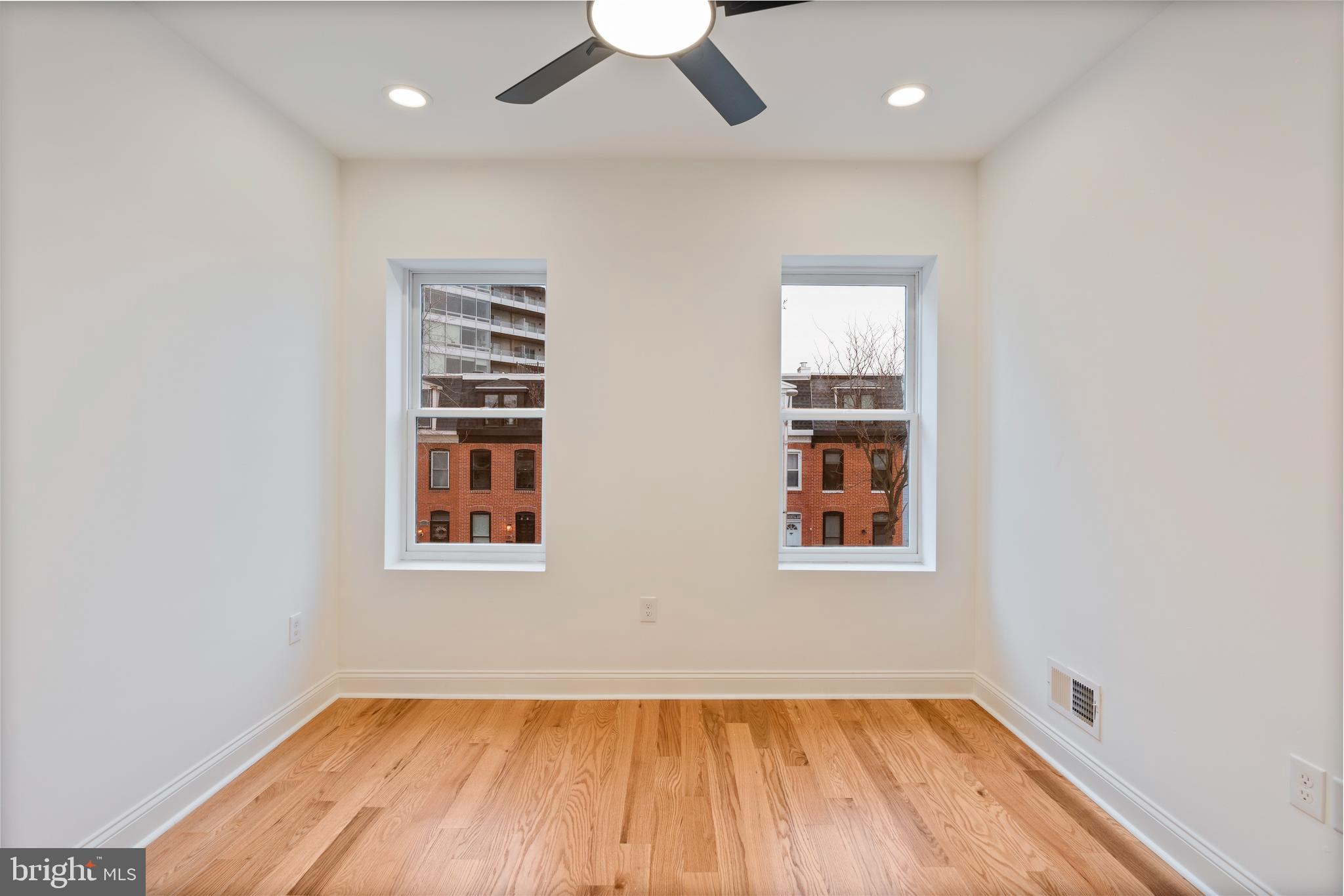 1352 Andre Street Baltimore, MD 21230 - Photo 29 of 52 an empty room with a window and wooden floor
