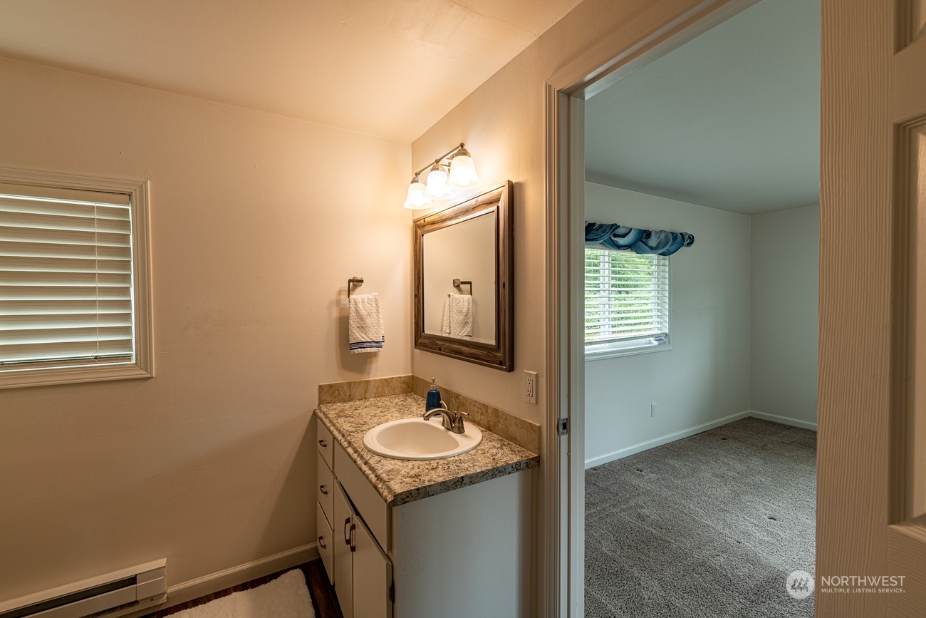 139 West Frostad Road Oak Harbor, WA 98277 - Photo 20 of 39 a bathroom with a granite countertop sink and a mirror