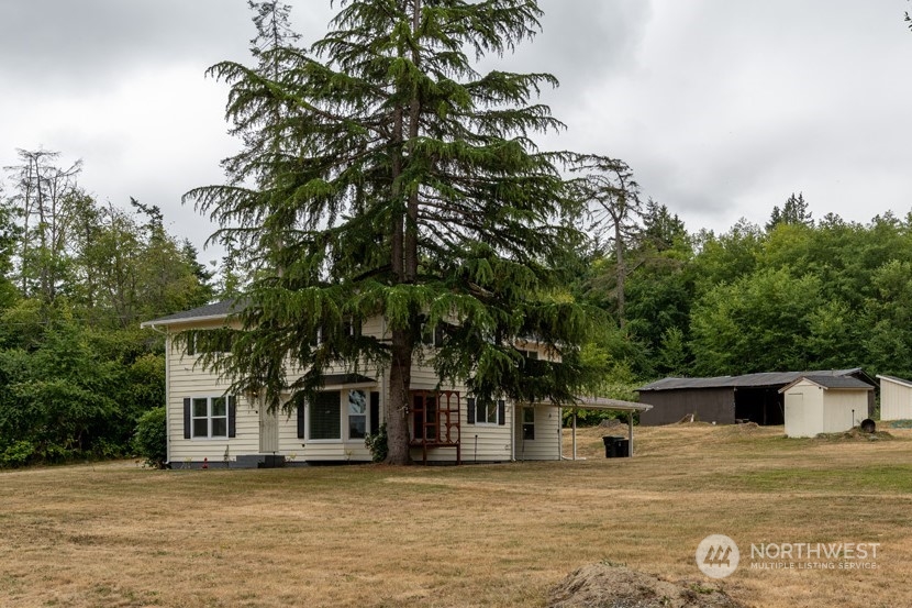 139 West Frostad Road Oak Harbor, WA 98277 - Photo 2 of 39 a front view of a house with a yard and trees