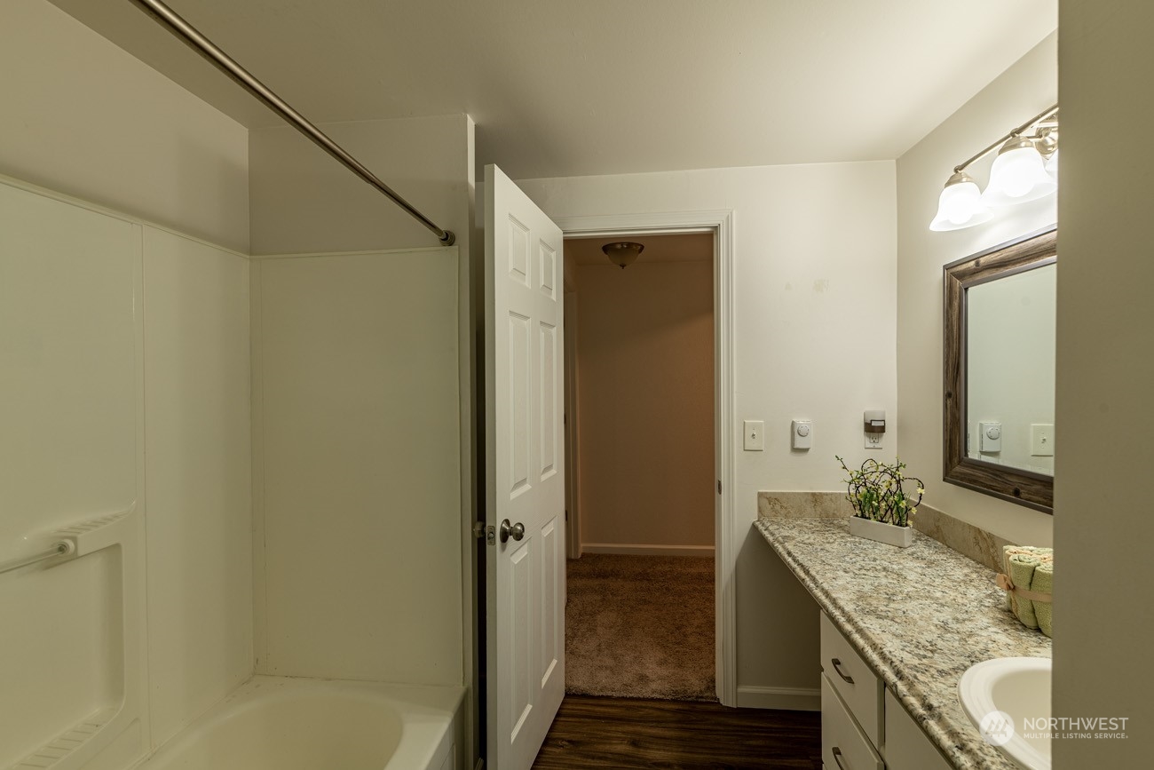 139 West Frostad Road Oak Harbor, WA 98277 - Photo 26 of 39 a bathroom with a granite countertop sink and a mirror