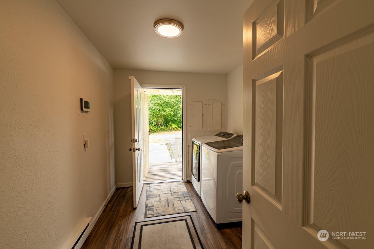 139 West Frostad Road Oak Harbor, WA 98277 - Photo 28 of 39 a view of a hallway with wooden floor and staircase