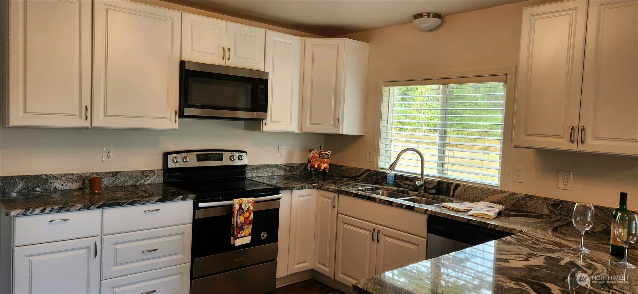 139 West Frostad Road Oak Harbor, WA 98277 - Photo 6 of 39 a kitchen with a sink stove top oven and cabinets