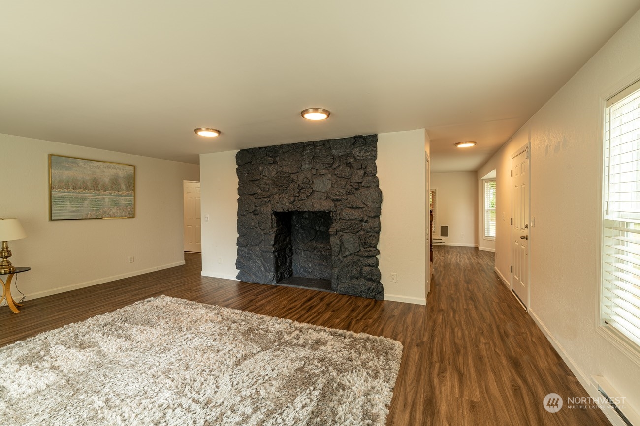 139 West Frostad Road Oak Harbor, WA 98277 - Photo 9 of 39 a view of a livingroom with wooden floor and a fireplace