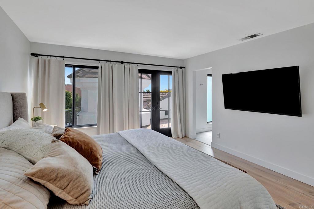 201 Sierra Ridge Drive Encinitas, CA 92024 - Photo 20 of 45 a bedroom with a bed tv and a large window