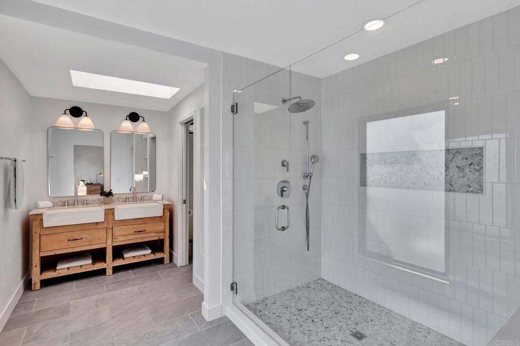 201 Sierra Ridge Drive Encinitas, CA 92024 - Photo 22 of 45 a bathroom with a double vanity sink mirror and shower