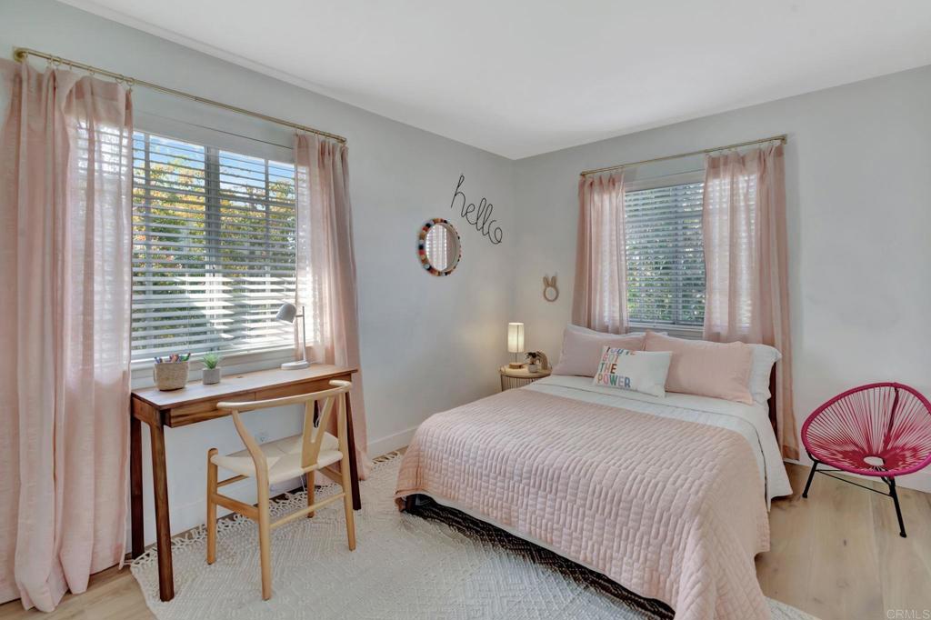 201 Sierra Ridge Drive Encinitas, CA 92024 - Photo 26 of 45 a bedroom with a bed and a table lamp