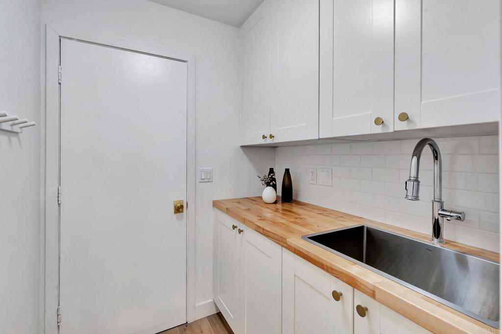 201 Sierra Ridge Drive Encinitas, CA 92024 - Photo 28 of 45 a kitchen with a sink and cabinets