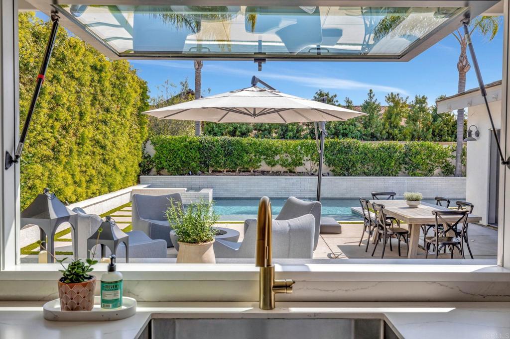 201 Sierra Ridge Drive Encinitas, CA 92024 - Photo 4 of 45 a view of a patio with table and chairs potted plants with wooden floor