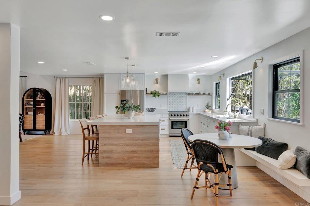 201 Sierra Ridge Drive Encinitas, CA 92024 - Photo 5 of 45 a kitchen with granite countertop white cabinets and stainless steel appliances