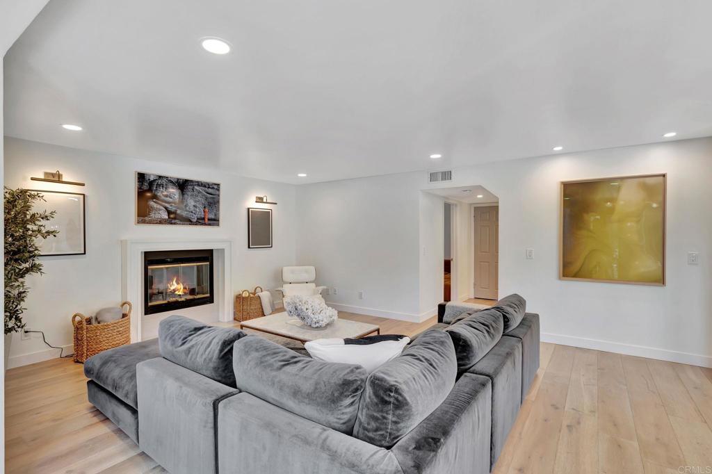 201 Sierra Ridge Drive Encinitas, CA 92024 - Photo 8 of 45 a living room with furniture a fireplace and a flat screen tv