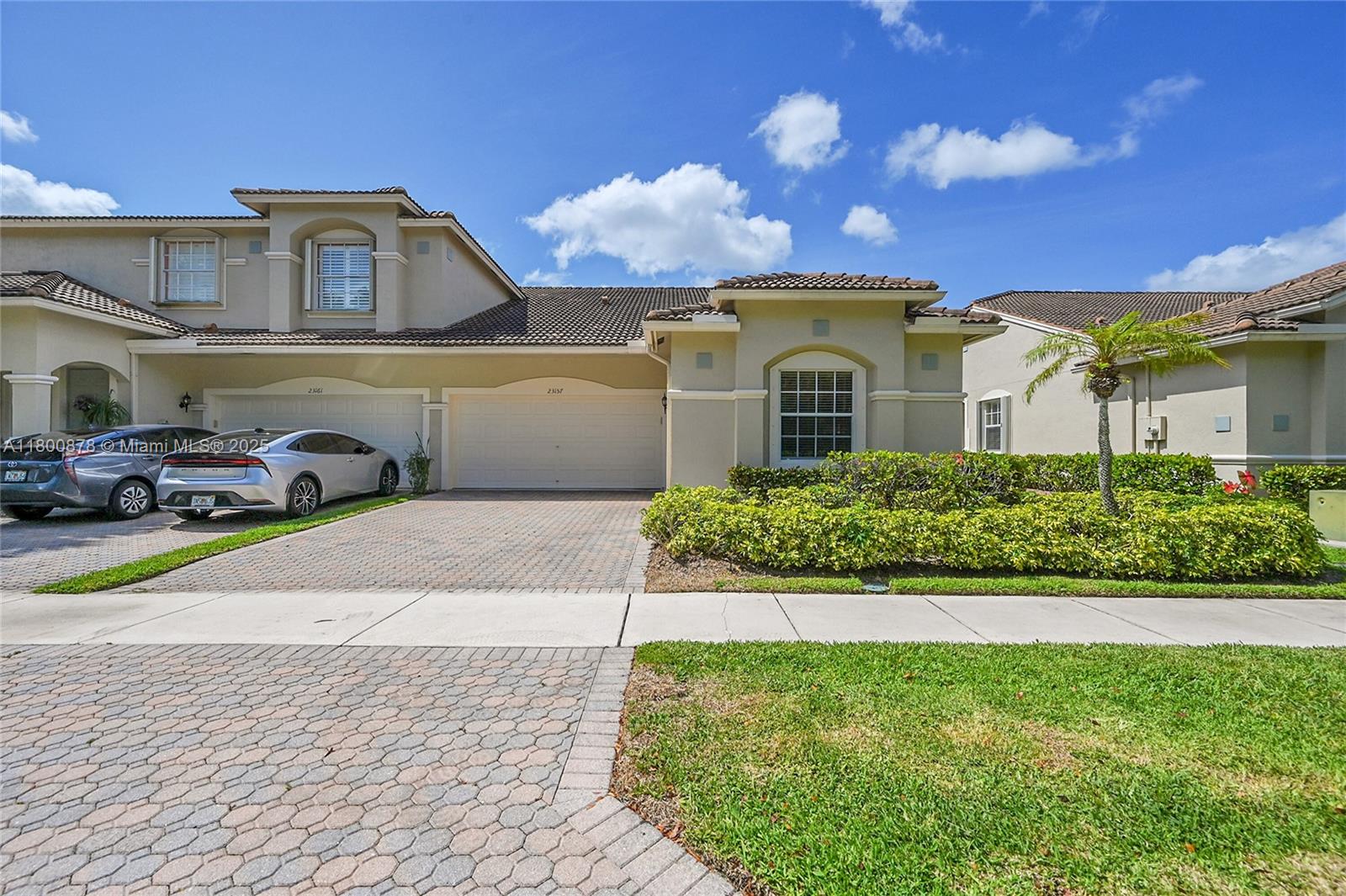 a front view of a house with a yard and a garage