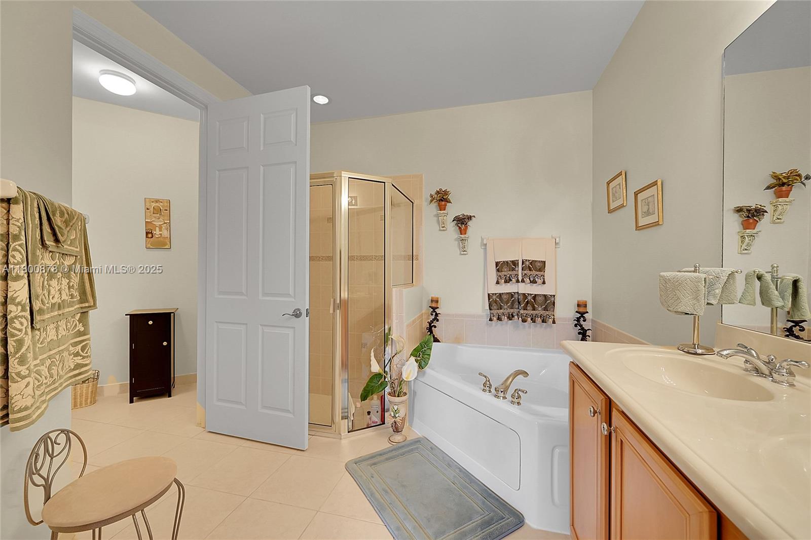 23157 Addison Lakes Circle Boca Raton, FL 33433 - Photo 16 of 30 a spacious bathroom with a tub sink and mirror