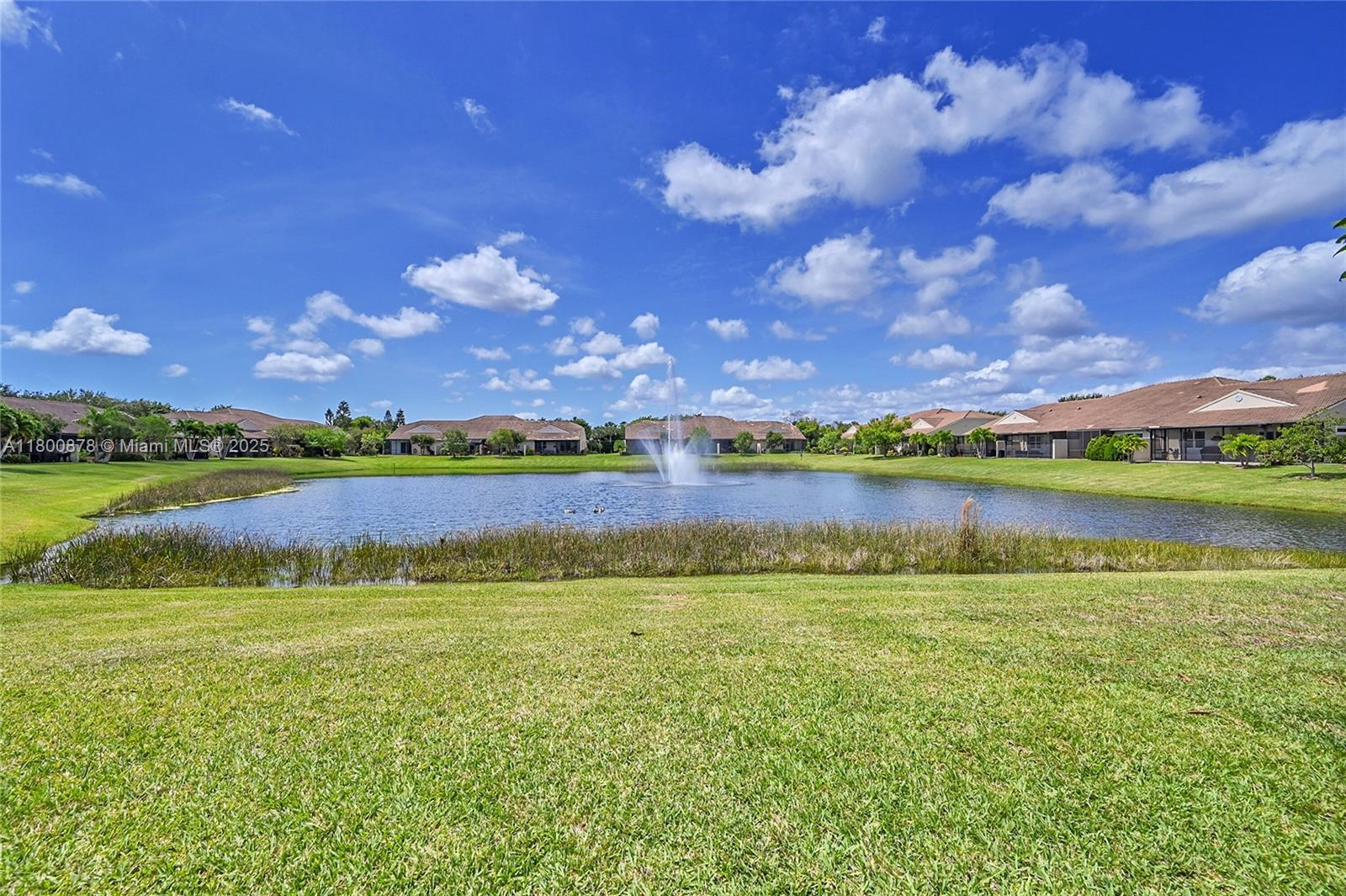 23157 Addison Lakes Circle Boca Raton, FL 33433 - Photo 26 of 30 a view of a lake with houses in the back