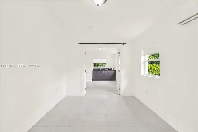 a view of a hallway with wooden floor and cabinet