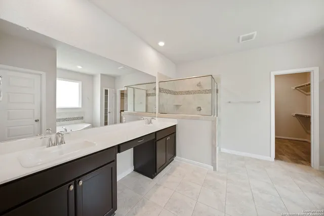 a bathroom with a granite countertop sink mirror and double