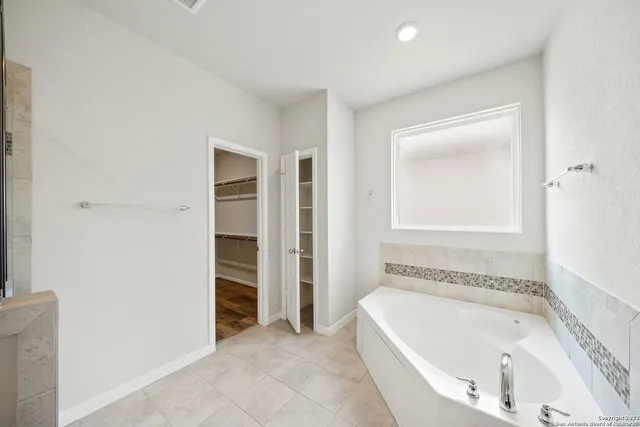 a bathroom with a bathtub and a sink