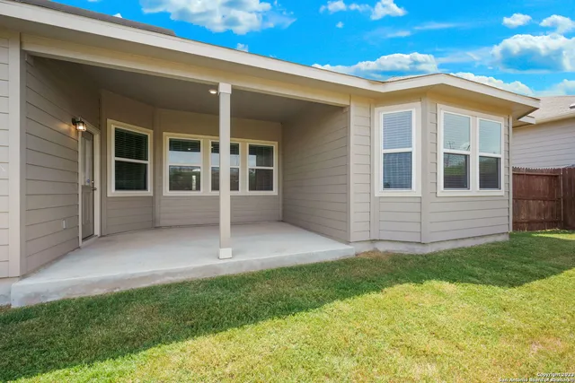a view of an house with backyard and porch