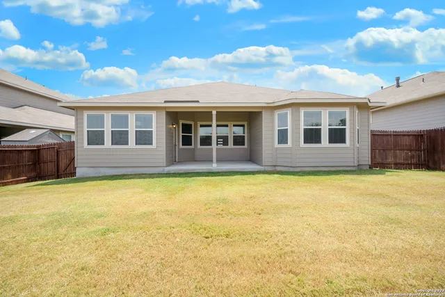 a view of a house with a swimming pool and a yard