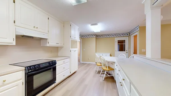 a bathroom with a tub a mirror and a sink