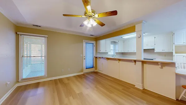 a view of an empty room with a fireplace and a window