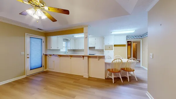 a view of empty room with fireplace and fan