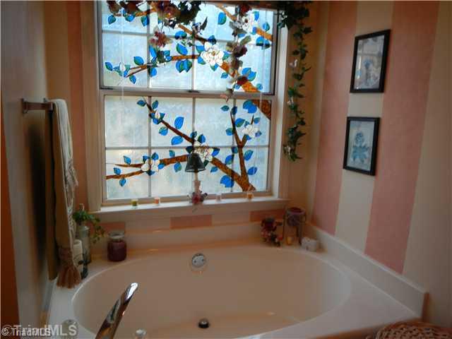 4103 Chilton Way High Point, NC 27265 - Photo 9 of 14 Master Bath/Spa. Master bath tub with private stain glass.