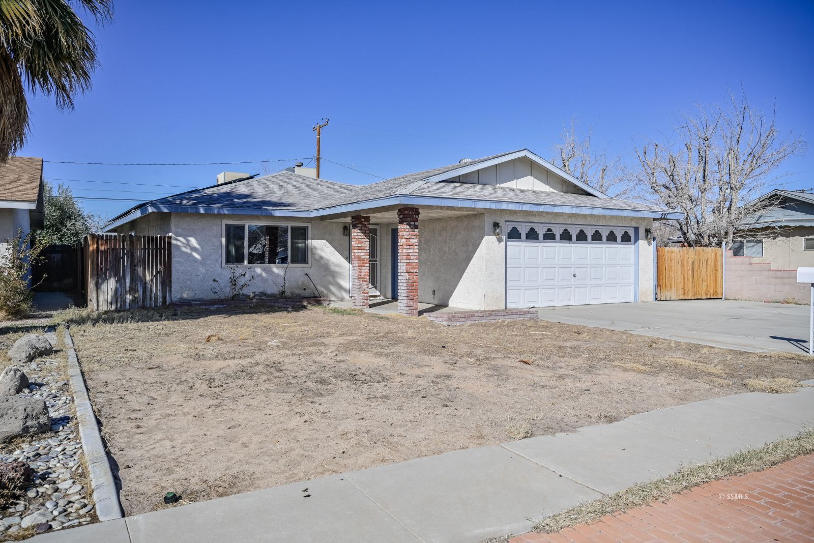 221 South Silver Ridge Street Ridgecrest, CA 93555 - Photo 2 of 44 a front view of a house with a yard