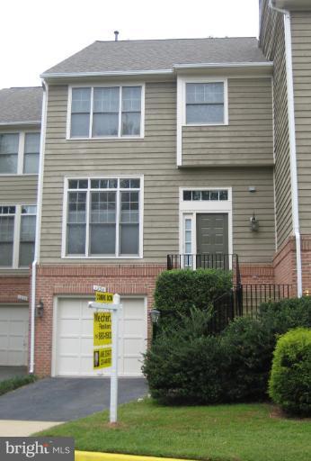 1234 Weatherstone Court Reston, VA 20194 - Photo 1 of 18 a front view of a house with a garden