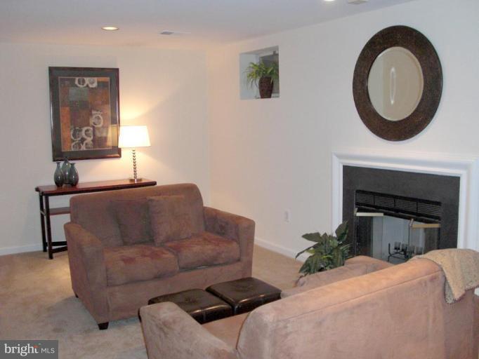 1234 Weatherstone Court Reston, VA 20194 - Photo 14 of 18 a living room with furniture a mirror and a fireplace