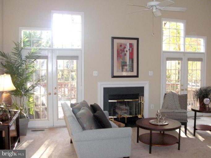 1234 Weatherstone Court Reston, VA 20194 - Photo 5 of 18 a living room with furniture a fireplace and a large window