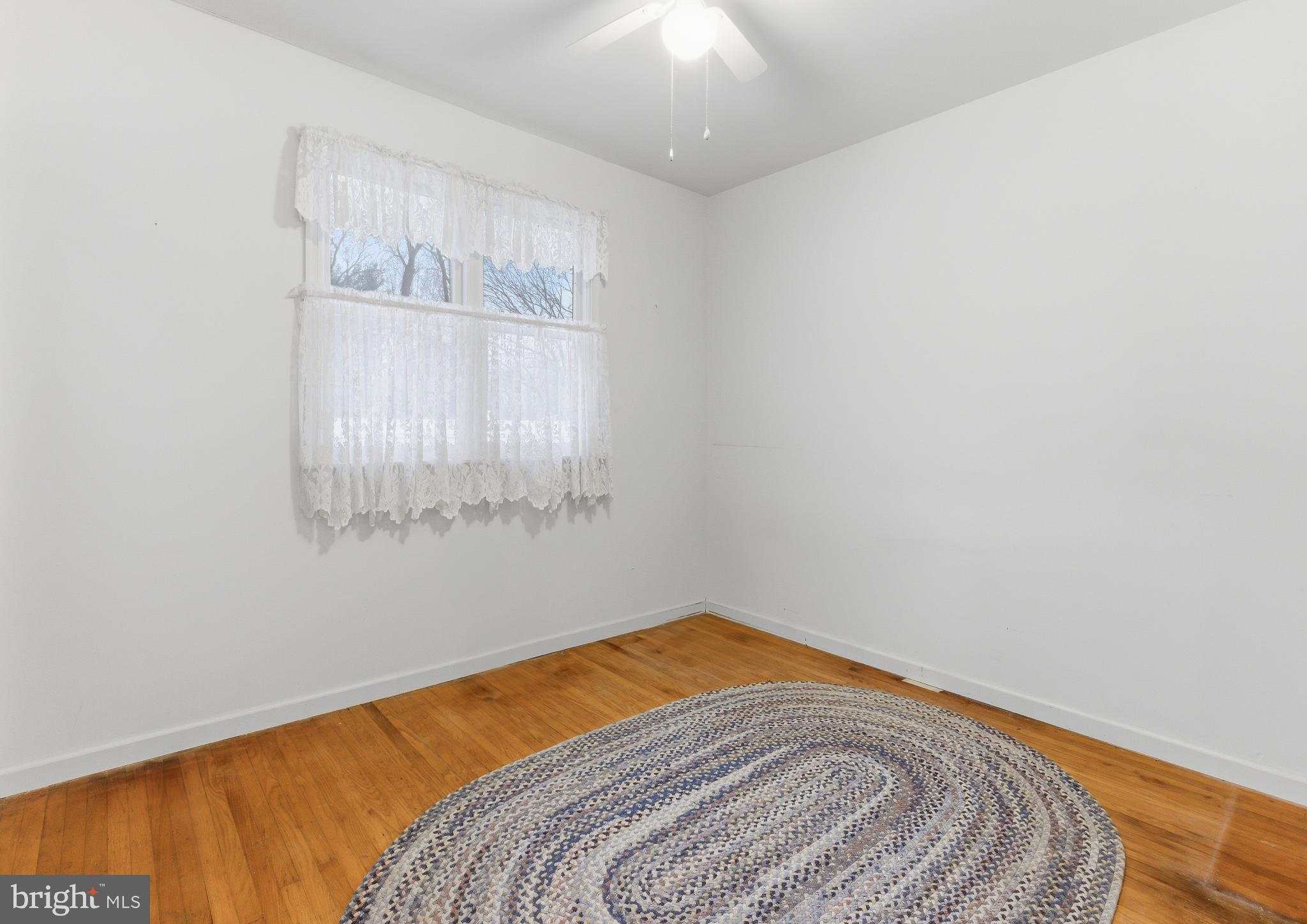 412 Alcyon Boulevard Pitman, NJ 08071 - Photo 18 of 22 a bedroom with a bed and a window