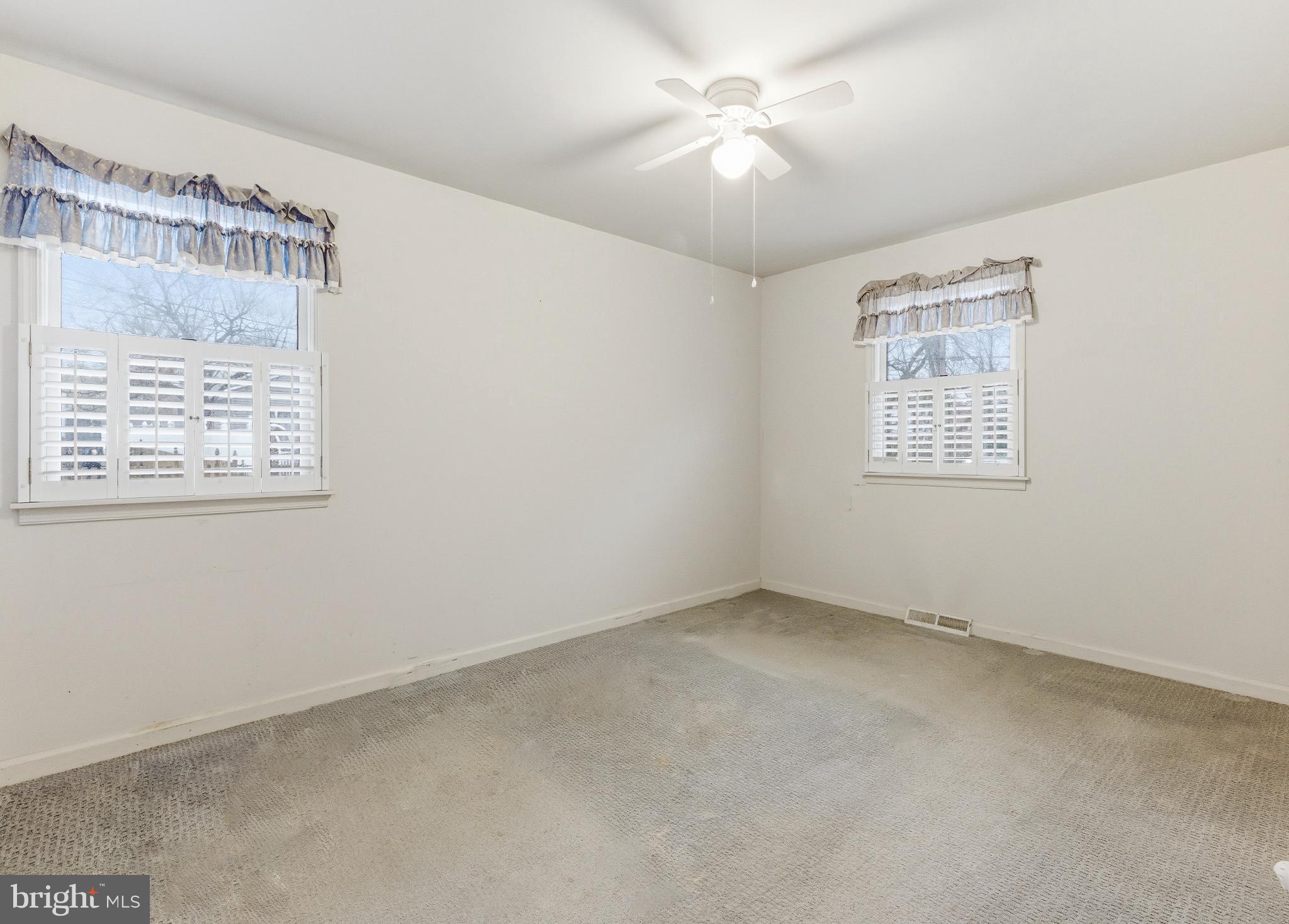 412 Alcyon Boulevard Pitman, NJ 08071 - Photo 19 of 22 an empty room with a window and a fan