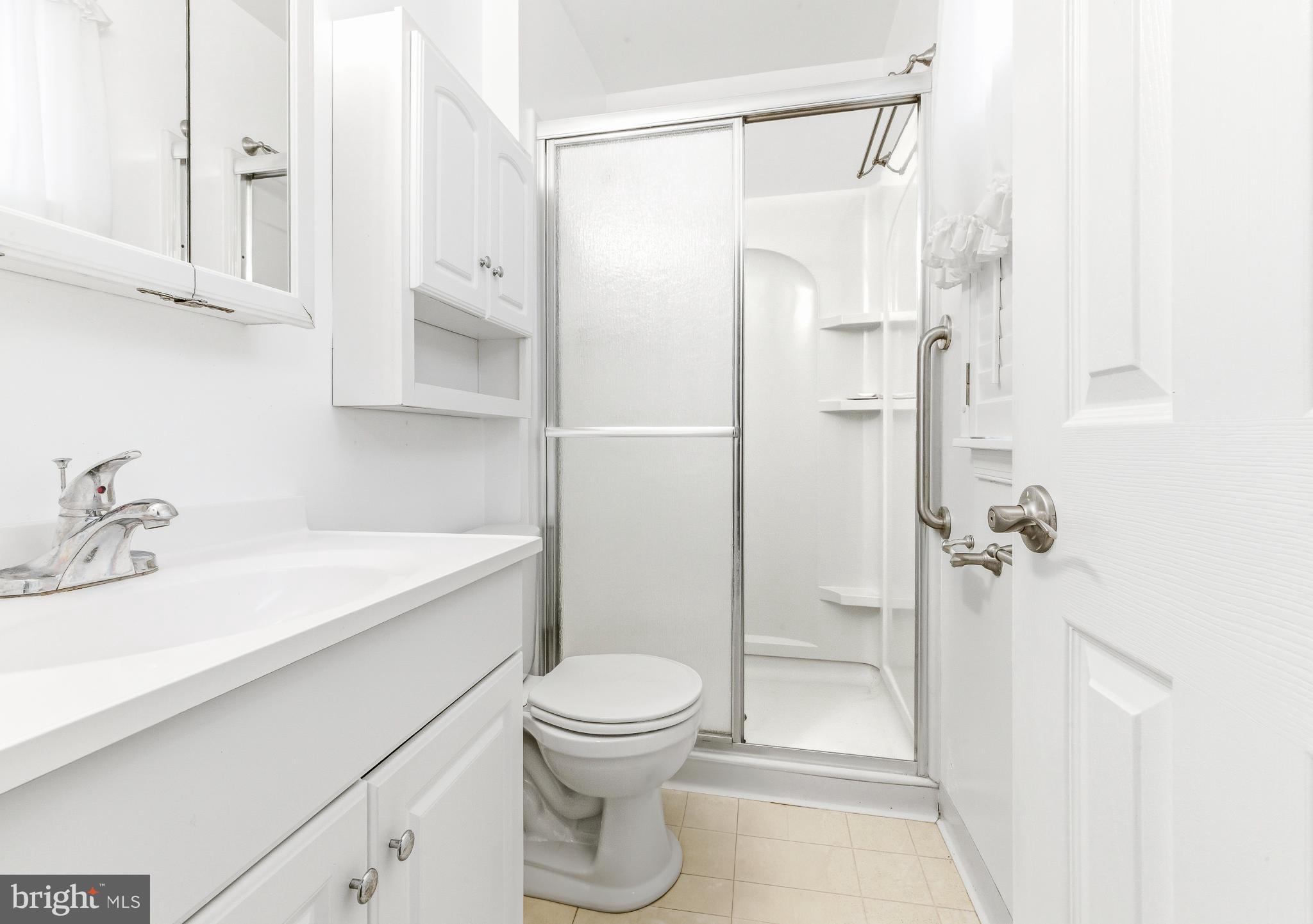 412 Alcyon Boulevard Pitman, NJ 08071 - Photo 21 of 22 a bathroom with a sink a toilet and shower