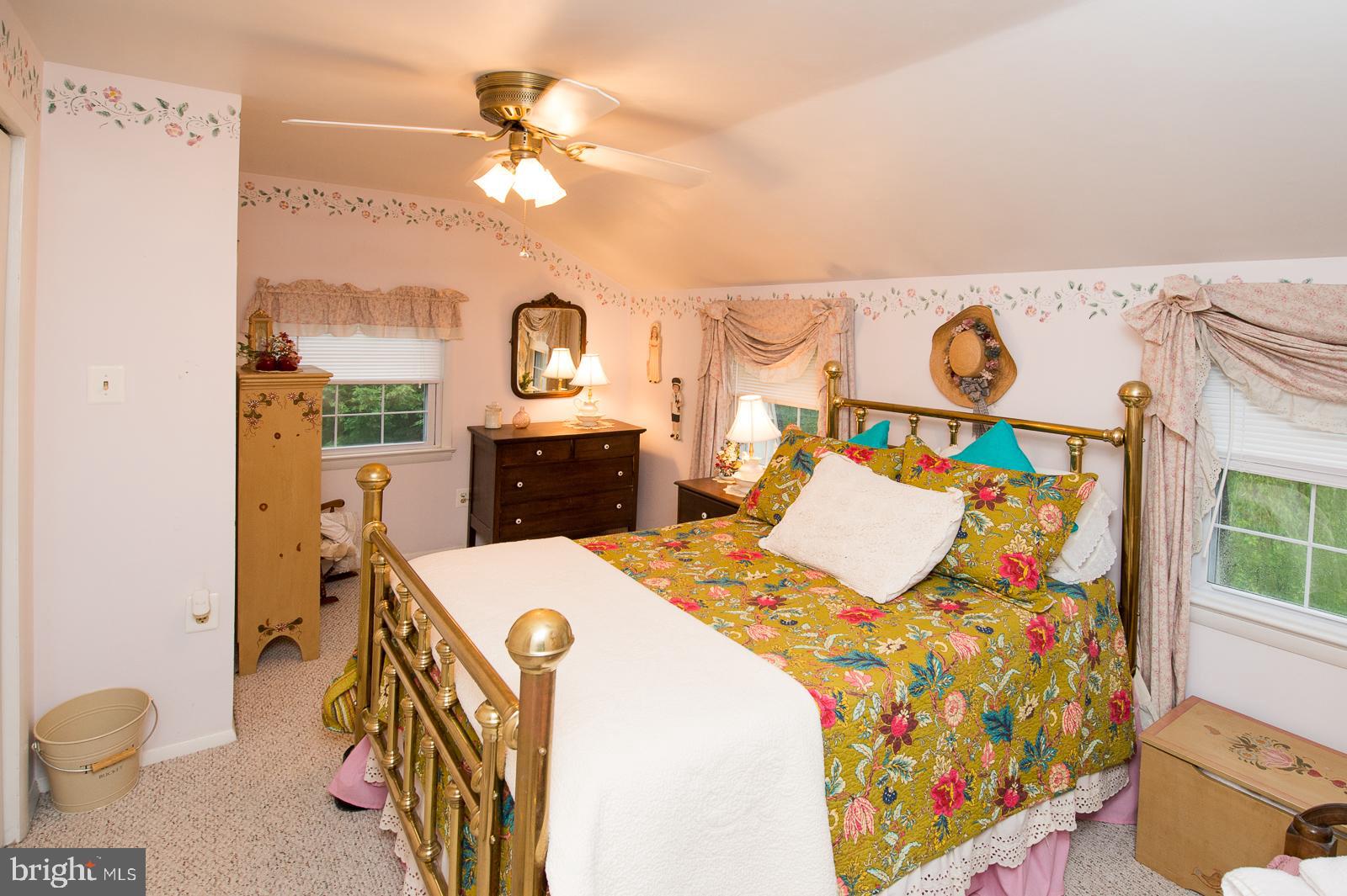 1251 Turkey Point Road Edgewater, MD 21037 - Photo 23 of 32 a bed room with a bed and a table in it