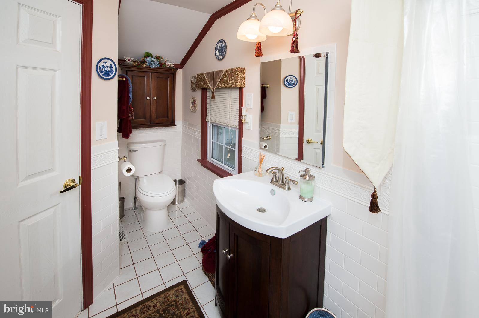 1251 Turkey Point Road Edgewater, MD 21037 - Photo 25 of 32 a bathroom with a sink mirror and toilet