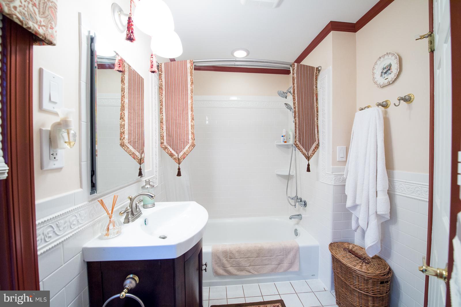 1251 Turkey Point Road Edgewater, MD 21037 - Photo 26 of 32 a bathroom with a tub sink and mirror