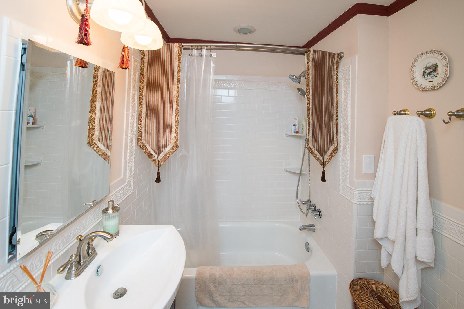 1251 Turkey Point Road Edgewater, MD 21037 - Photo 27 of 32 a bathroom with a sink and a shower