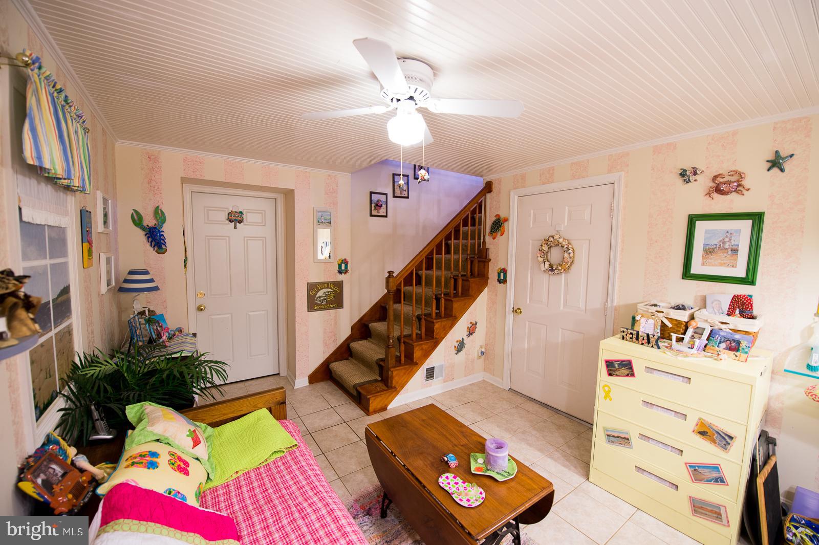 1251 Turkey Point Road Edgewater, MD 21037 - Photo 29 of 32 a bedroom with furniture a bed and a chandelier