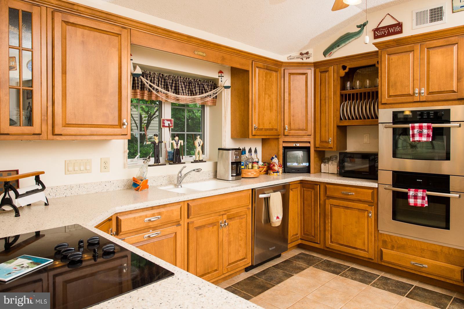 1251 Turkey Point Road Edgewater, MD 21037 - Photo 8 of 32 a kitchen with stainless steel appliances granite countertop a refrigerator and sink