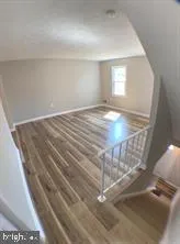 a view of wooden floor and window in a room
