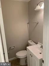 a white toilet sitting next to a bathroom sink