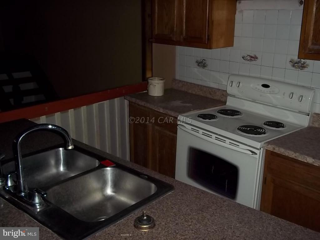 27223 Mt Vernon Road Princess Anne, MD 21853 - Photo 3 of 11 a kitchen with a stove and a sink