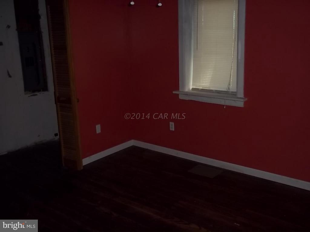 27223 Mt Vernon Road Princess Anne, MD 21853 - Photo 6 of 11 a view of an empty room with wooden floor and a window