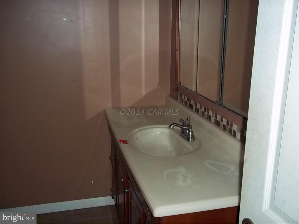 27223 Mt Vernon Road Princess Anne, MD 21853 - Photo 8 of 11 a bathroom with a sink and a mirror