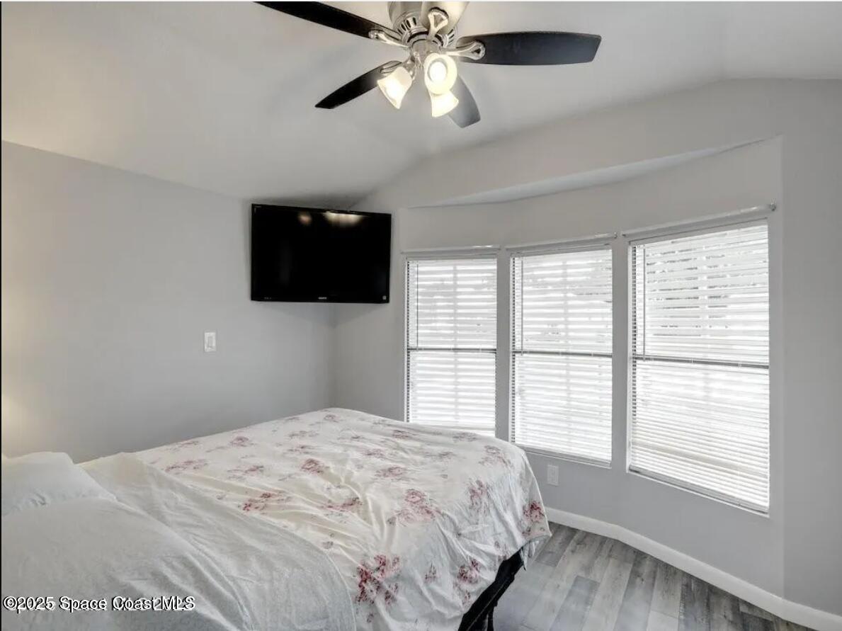 7560 Blackhawk Road Sebastian, FL 32976 - Photo 12 of 13 a bedroom with a bed and a flat screen tv