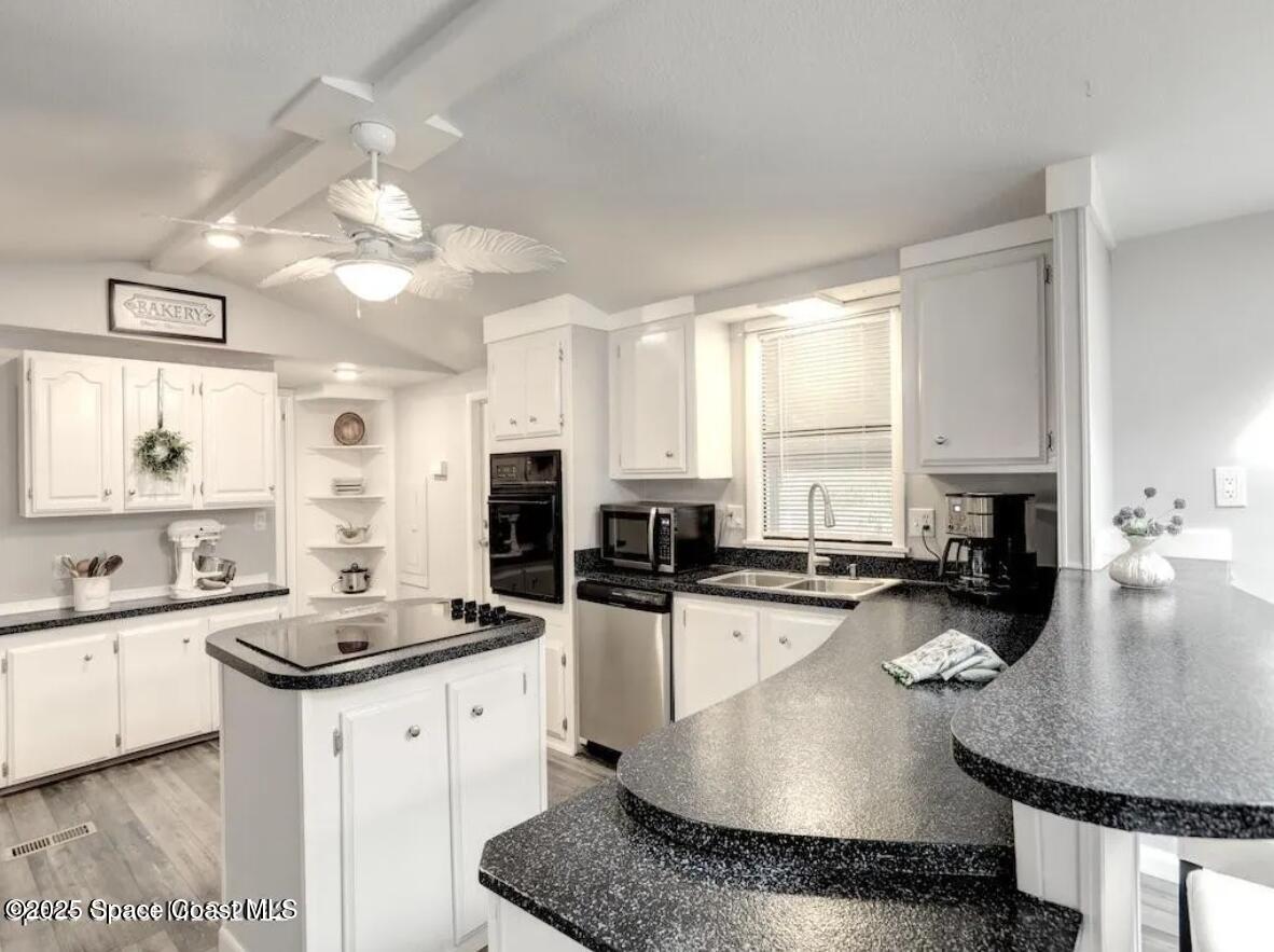 7560 Blackhawk Road Sebastian, FL 32976 - Photo 6 of 13 a kitchen with stainless steel appliances granite countertop a sink a stove cabinets counter space and living room view