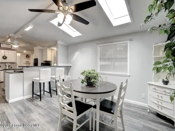 a view of a dining room with furniture and wooden floor